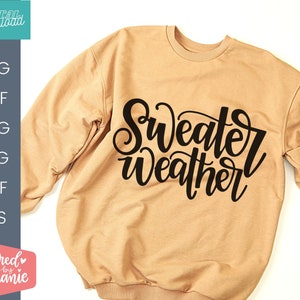 May include: A tan sweatshirt with the text "Sweater Weather" in black cursive lettering.