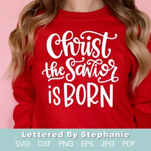 May include: Red sweatshirt with white lettering that reads "Christ the Savior is Born".