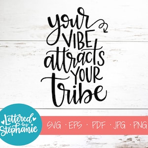 May include: Black and white text graphic design on a white wood background. The text reads "Your vibe attracts your tribe".