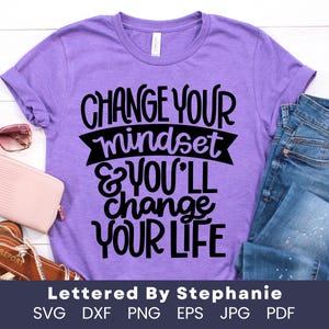 May include: Purple t-shirt with the text "Change your mindset & you'll change your life" in black lettering.