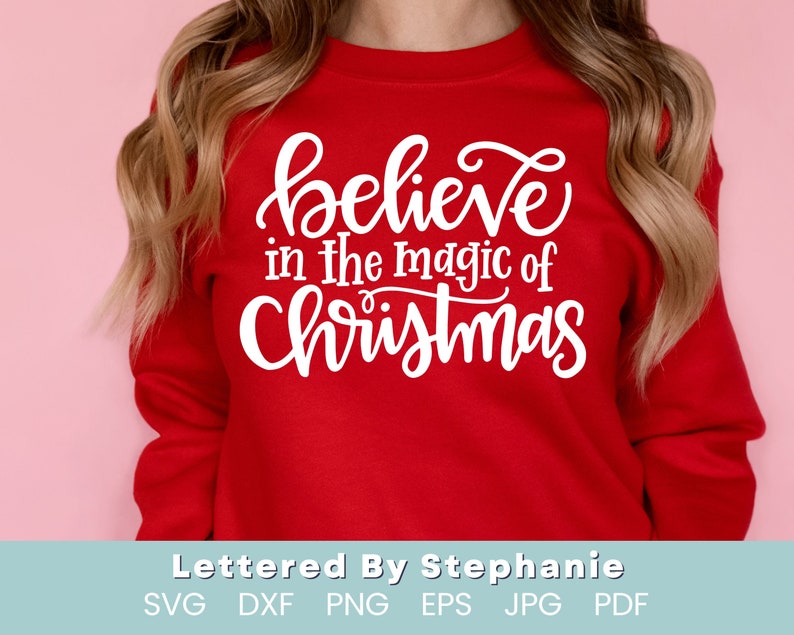 May include: Red sweatshirt with white text that reads "believe in the magic of Christmas".