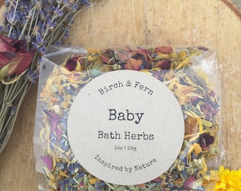 May include: A clear plastic bag filled with dried herbs and flowers for a baby bath. The label reads "Birch & Fern Baby Bath Herbs 1 oz | 28g Inspired by Nature".