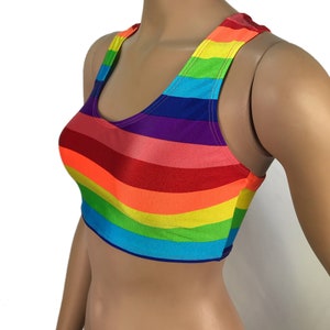 May include: Rainbow striped crop top with a scoop neck and racerback style.