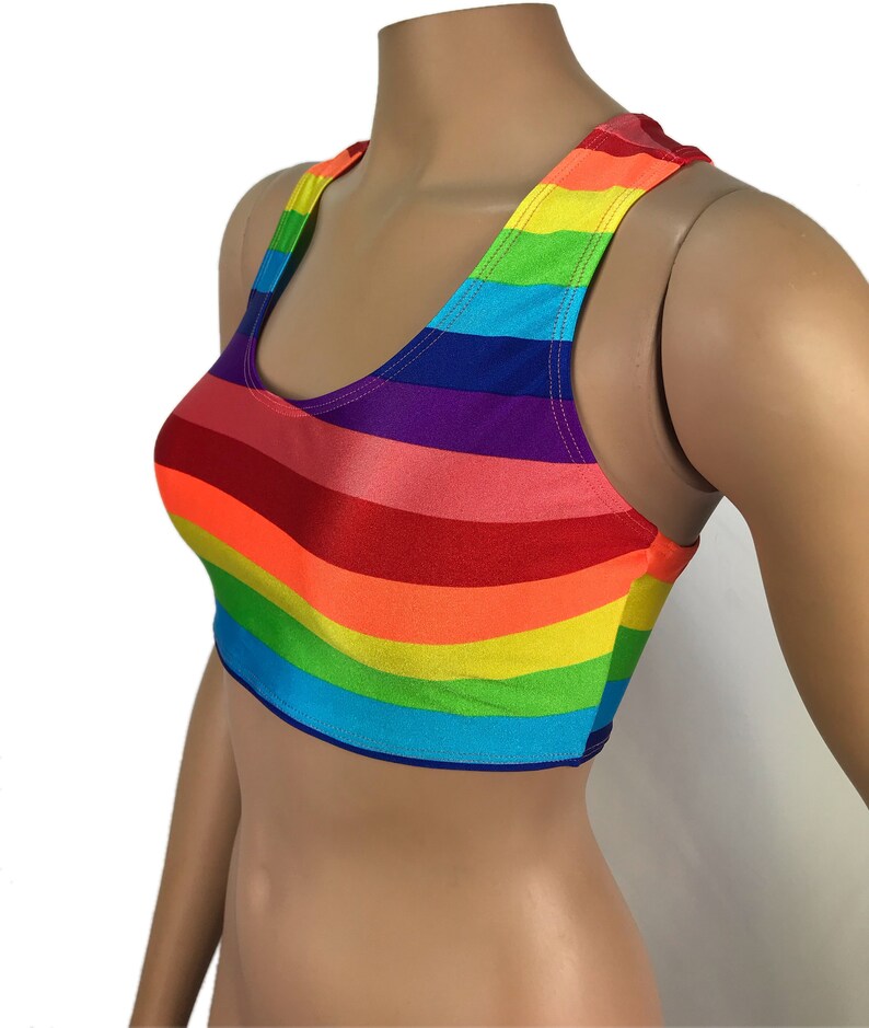 May include: Rainbow striped crop top with a scoop neck and racerback style.