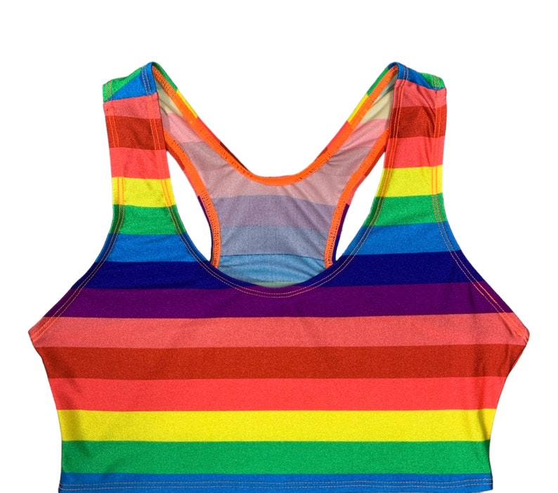 May include: A rainbow striped racerback tank top with a scoop neck.