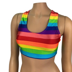 May include: A rainbow striped crop top with a racerback style. The top is made of a stretchy, shiny fabric.