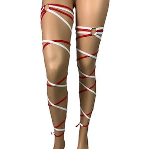 May include: Red and white leg wraps with a ring at the top. The wraps are tied around the legs and are crisscrossed.