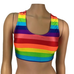May include: A rainbow striped crop top with a scoop neck and racerback style. The top is made of a stretchy, shiny fabric.