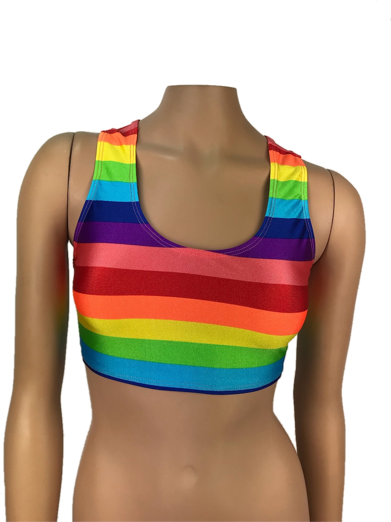 May include: A rainbow striped crop top with a scoop neck and racerback style. The top is made of a stretchy, shiny fabric.