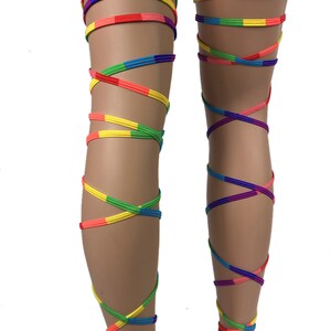 May include: Rainbow colored leg wraps, tied around the legs in a criss-cross pattern. The wraps are made of a soft, stretchy material and are perfect for adding a pop of color to any outfit.
