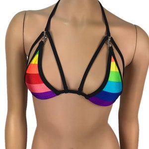 May include: Rainbow striped bikini top with black straps and adjustable clasps. The top has a criss-cross design in the front.