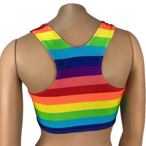 May include: A rainbow striped tank top with a racerback style. The tank top is cropped and has a bright, colorful design.