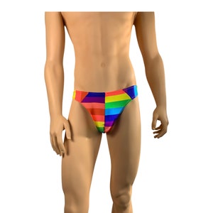 May include: A pair of rainbow-colored briefs. The briefs are divided into vertical sections of red, orange, yellow, green, blue, and purple. The briefs are on a mannequin.