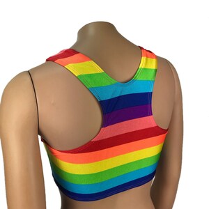 May include: A rainbow striped sports bra with a racerback style. The bra is made of a stretchy, comfortable fabric and has a bright, colorful design.