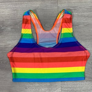May include: A rainbow striped tank top with a racerback style. The top is made of a stretchy, comfortable fabric.