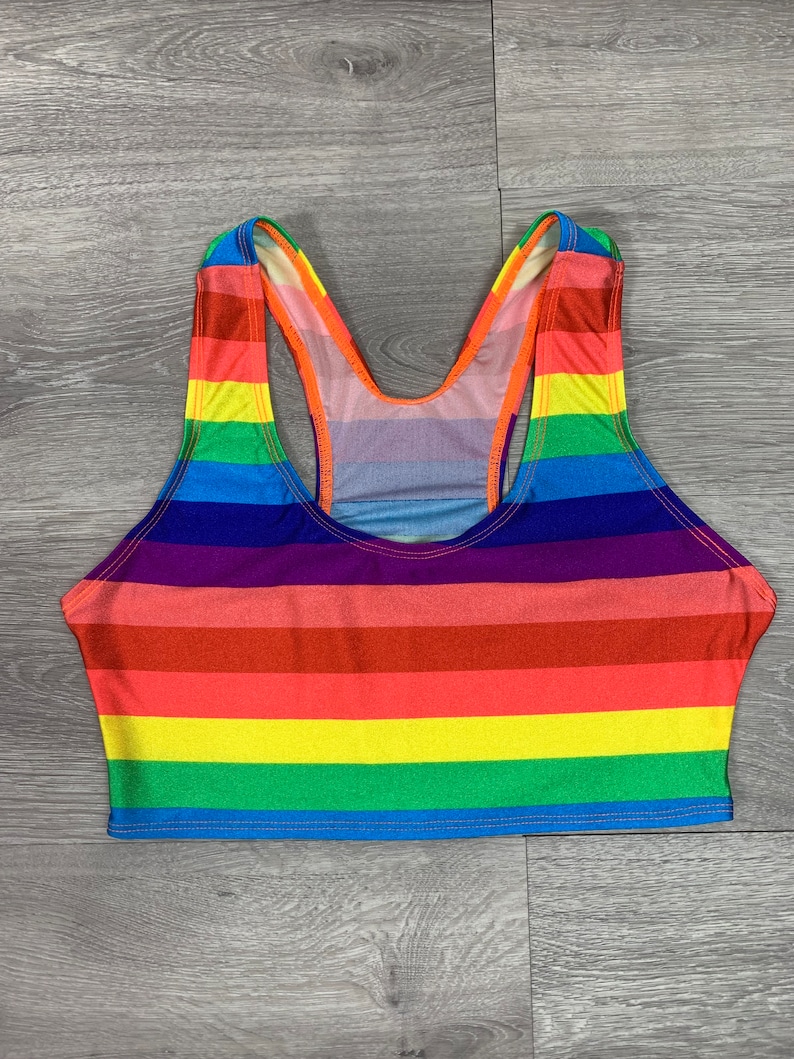 May include: A rainbow striped tank top with a racerback style. The top is made of a stretchy, comfortable fabric.