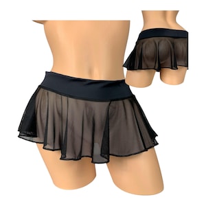 May include: A black mini skirt featuring a solid opaque waistband and a sheer, pleated mesh lower section. The garment is displayed on a mannequin, showing both a front view and a smaller inset view of the back, highlighting the flared silhouette.