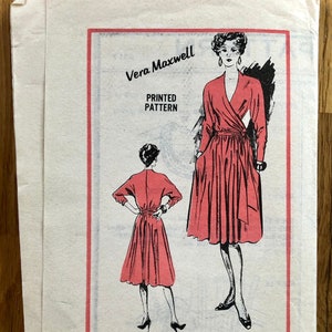 May include: A vintage Vera Maxwell printed dressmaking pattern, size 16. The cover shows illustrations of the dress in red, with a wrap-style bodice and a flared skirt. The text reads "Prominent Designer".