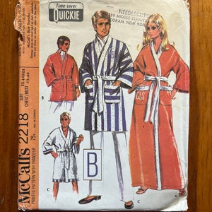 May include: A vintage McCall's 2218 sewing pattern envelope featuring illustrations of three different robe styles. The cover displays text including Time-saver Quickie, McCall's 2218, and size information for chest and bust measurements of 42-44 inches.