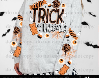 May include: A light gray long-sleeve sweatshirt featuring a Halloween-themed graphic with the text "TRICK or treat" in black and orange. The design includes orange and black candy, gummy bears, eyeballs, spiderwebs, and small white ghosts.