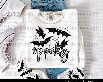 May include: White sweatshirt with a black bat and star design, and the word "spooky" in a script font. The image includes a pair of blue jeans, white sneakers, and a gold chain. The text "PNG DIGITAL FILE" and "Cerra's Shop creates" are also visible.