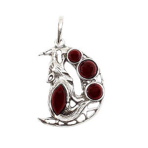 May include: A silver pendant with a stylized design featuring a crescent shape and a bird-like figure. The pendant is adorned with three round and one oval, deep red gemstones. The bail is a simple loop for a chain.