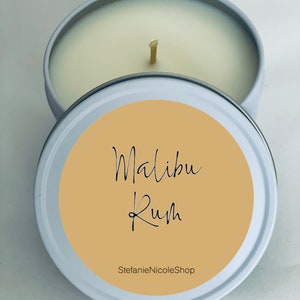 May include: A white candle tin with a beige label that reads "Malibu Rum" and "StefanieNicoleShop".