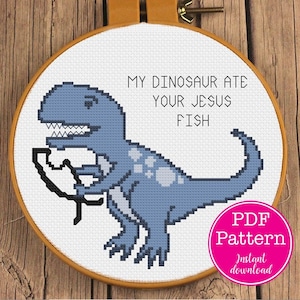 May include: A cross-stitch pattern featuring a blue dinosaur eating a fish with the text "My dinosaur ate your Jesus fish". The pattern is available as a PDF download.