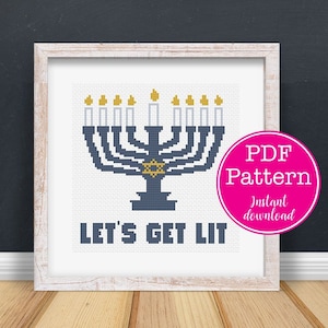 May include: Cross-stitch pattern of a blue menorah with lit candles and a Star of David. The text "LET'S GET LIT" is below the menorah. A pink circle with "PDF Pattern" and "Instant download" is on the right.