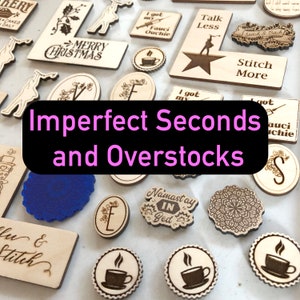 May include: A collection of wooden laser-cut ornaments with various designs and sayings, including "Merry Christmas", "Talk Less", "Stitch More", "I got my Fauci Ouchie", and "Namastay in Bed". The ornaments are labeled "Imperfect Seconds and Overstocks".