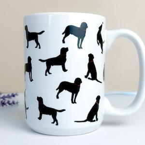 May include: White ceramic mug featuring black dog silhouettes with red collars. The mug has a curved handle and is decorated with various poses of dogs, creating a playful and charming design. A perfect gift for dog lovers.