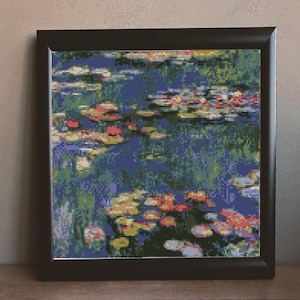 May include: Framed painting of a water lily pond with blue water, green lily pads, and pink and yellow flowers.