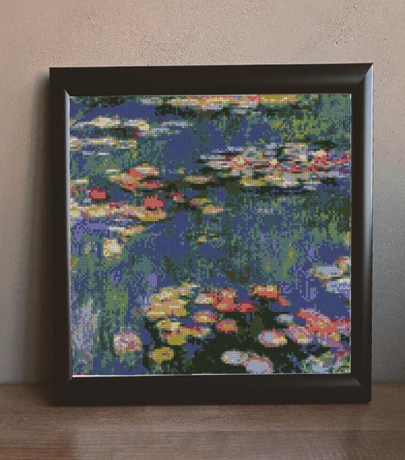 May include: Framed painting of a water lily pond with blue water, green lily pads, and pink and yellow flowers.
