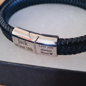 May include: Black braided leather bracelet with a silver clasp, presented in a black gift box. The clasp is engraved with the words "Jack on your 18th" and "Love you always Mum".