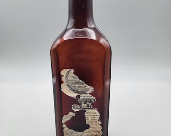 Antica bottiglia di olio di fegato di merluzzo Ferrol, in vetro ambrato con etichetta originale.