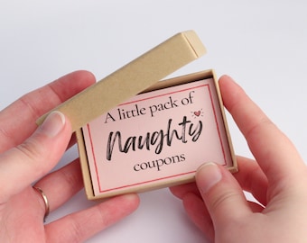 May include: A small, brown box with a pink card inside. The card says "A little pack of naughty coupons".
