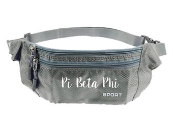 May include: Gray fanny pack with two zippered compartments and an adjustable strap. The text "Pi Beta Phi SPORT" is printed on the front. The fanny pack is made of a lightweight, textured material.