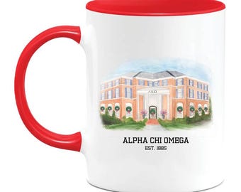 May include: White ceramic mug with a red interior and handle. The mug features a watercolor illustration of a building with columns and wreaths, with the text "ALPHA CHI OMEGA EST. 1885".