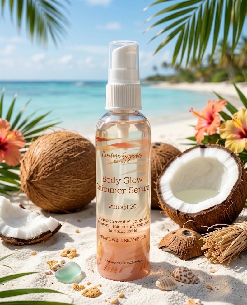 May include: A clear bottle of Body Glow Shimmer Serum with SPF 20 from Carolina Organics Soap Co. is displayed on a sandy beach. The bottle is surrounded by coconuts, flowers, and seashells. The text on the bottle reads "SHAKE WELL BEFORE USE."