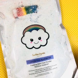 May include: A white resealable bag filled with white bath fizz powder. The bag has a rainbow cloud with a smiley face and the text "Over the Rainbow Foaming Bath Fizzy Powder Rainbow Surprise!"  Directions: Use as much as or as little as you want! Can be used more than once! Warning: Keep away from small children and pets. Handcrafted in South Carolina Facebook.com/CarolinaOrganicsSoapCo",