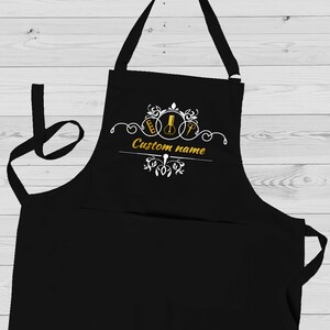 May include: Black apron with a white design featuring musical notes and the text "Custom name".