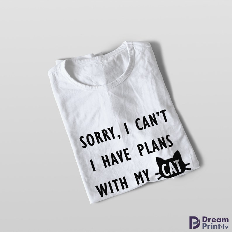 May include: White t-shirt with black text that reads "Sorry, I can't I have plans with my cat." A black cat silhouette with the word "cat" inside is next to the text.