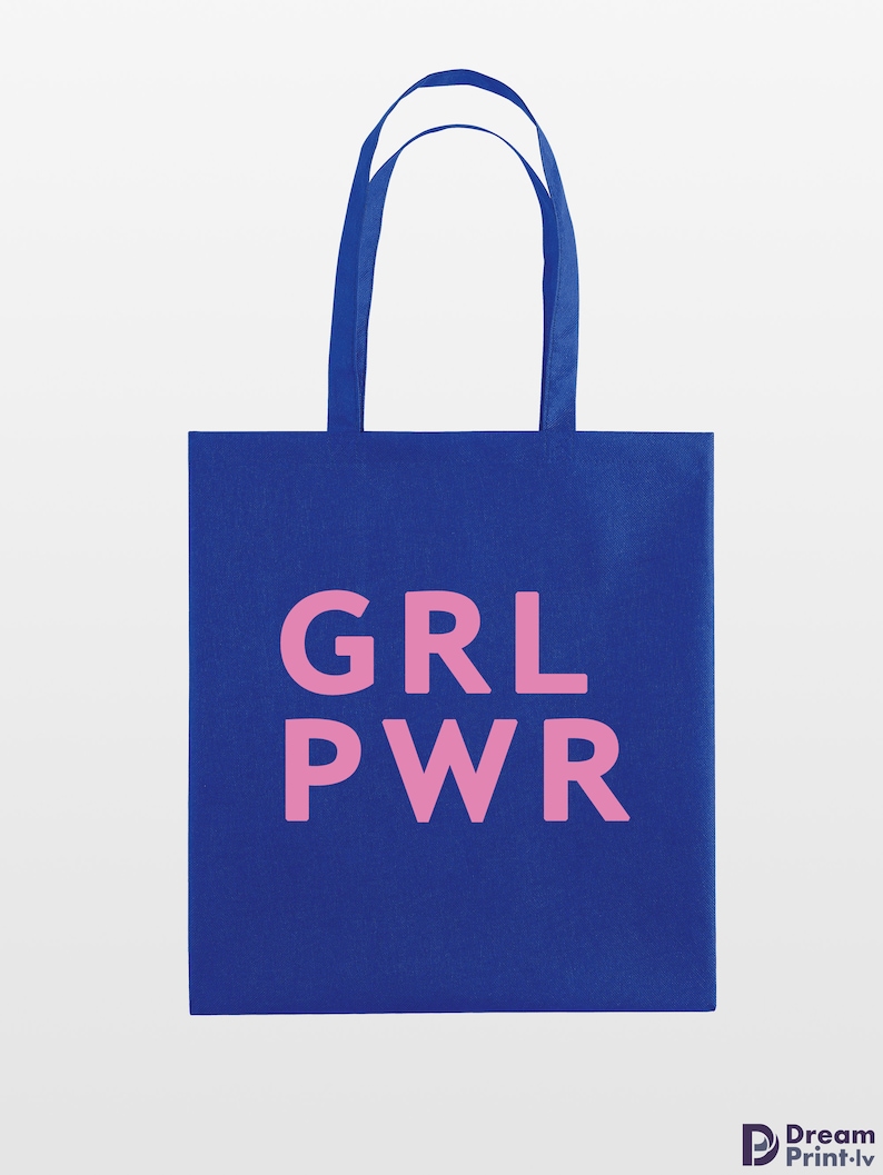 May include: A blue tote bag with pink text that reads "GRL PWR". The bag has two blue handles and is made of a sturdy fabric. The design is simple and bold, perfect for carrying books, groceries, or other items.