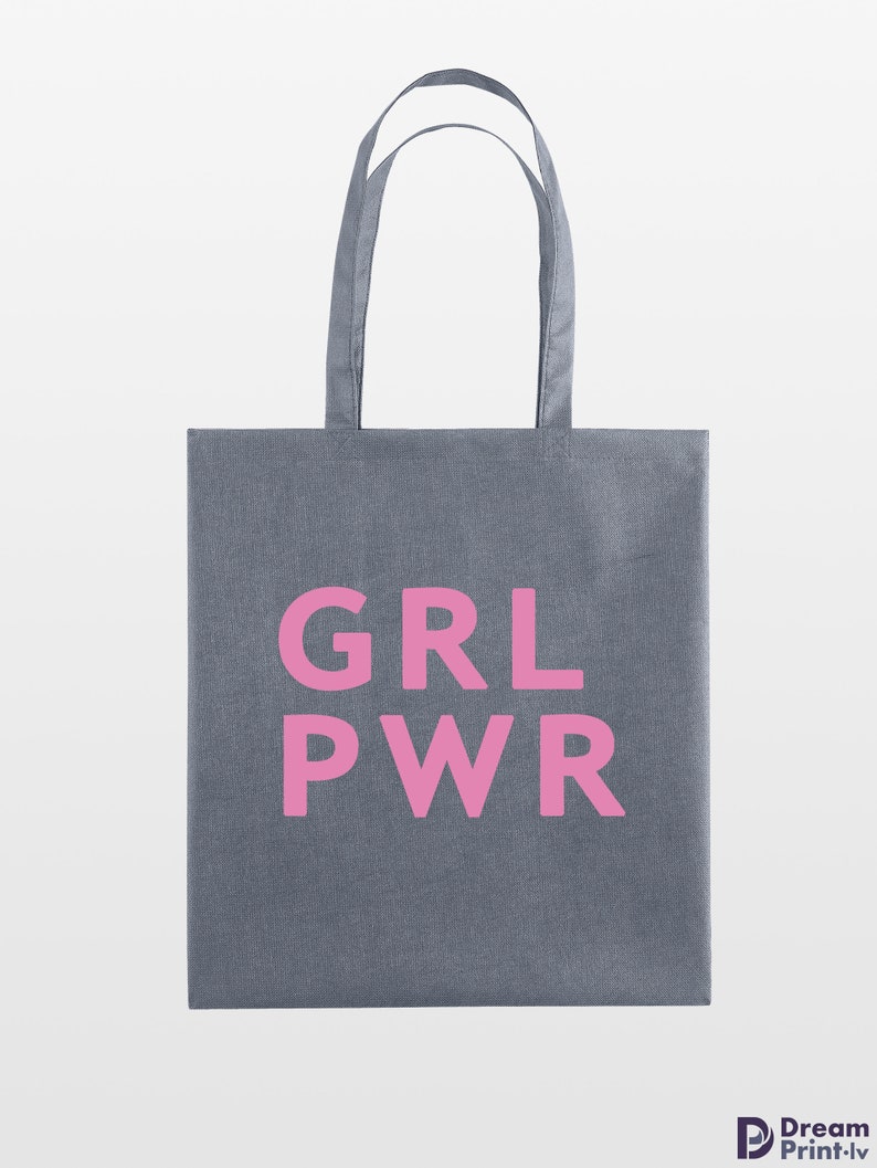 May include: Gray tote bag with the pink text "GRL PWR" printed on the front. The bag has two handles and is made of a sturdy fabric. The background is plain white.