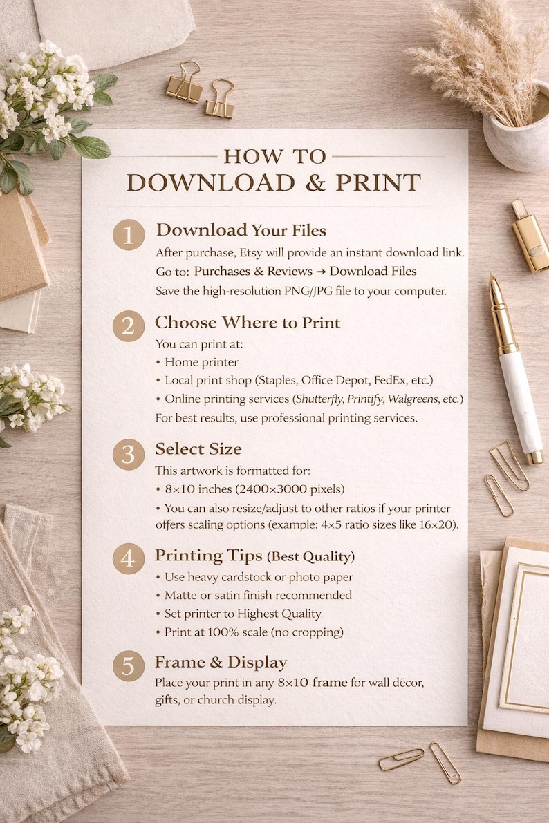 May include: A beige print with instructions on how to download and print artwork. The text includes steps for downloading files, choosing a print location, selecting a size (20x25 cm), printing tips, and framing. Decorative elements include gold paper clips and a pen.