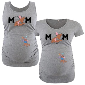 May include: Two gray maternity shirts. One is a tank top, the other a v-neck tee. Both feature the word "MOM" in black, with a kangaroo graphic inside a heart. A smaller kangaroo graphic with butterflies is below.