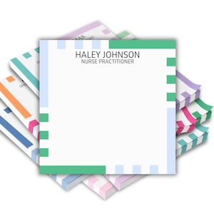 May include: A stack of personalized notepads with a white background. The top notepad features the name "Haley Johnson" and the title "Nurse Practitioner." The notepads have colorful striped edges in shades of blue, green, pink, and orange.