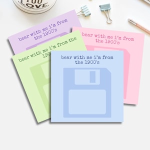 May include: A collection of pastel-colored sticky notes with a floppy disk design. Each note has the phrase "bear with me I'm from the 1900's" printed in a matching color. The notes are light blue, pink, green, and purple.