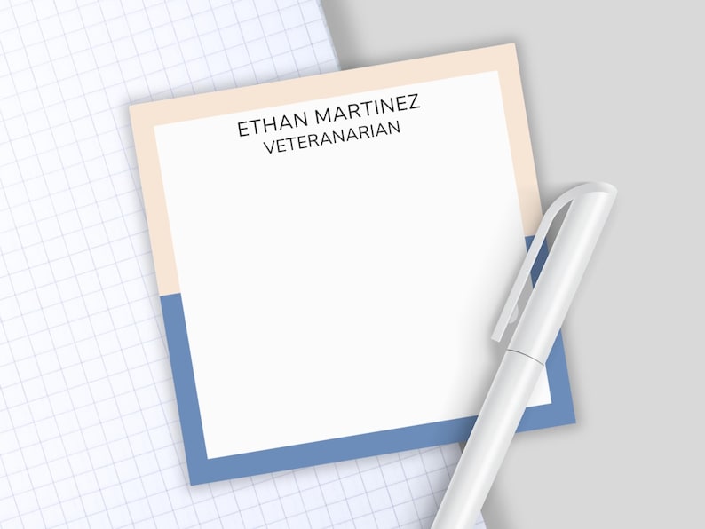 May include: A square notepad with a white center and a border split horizontally between light peach and blue. The text ETHAN MARTINEZ VETERANARIAN is printed in black at the top. A white pen is positioned diagonally across the notepad.