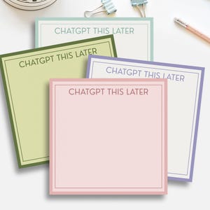 May include: A collection of square sticky notes in pastel colors: light green, pink, light blue, and lavender. Each note has a colored border and the text "CHATGPT THIS LATER" printed in a simple font. Pencils and binder clips are in the background.